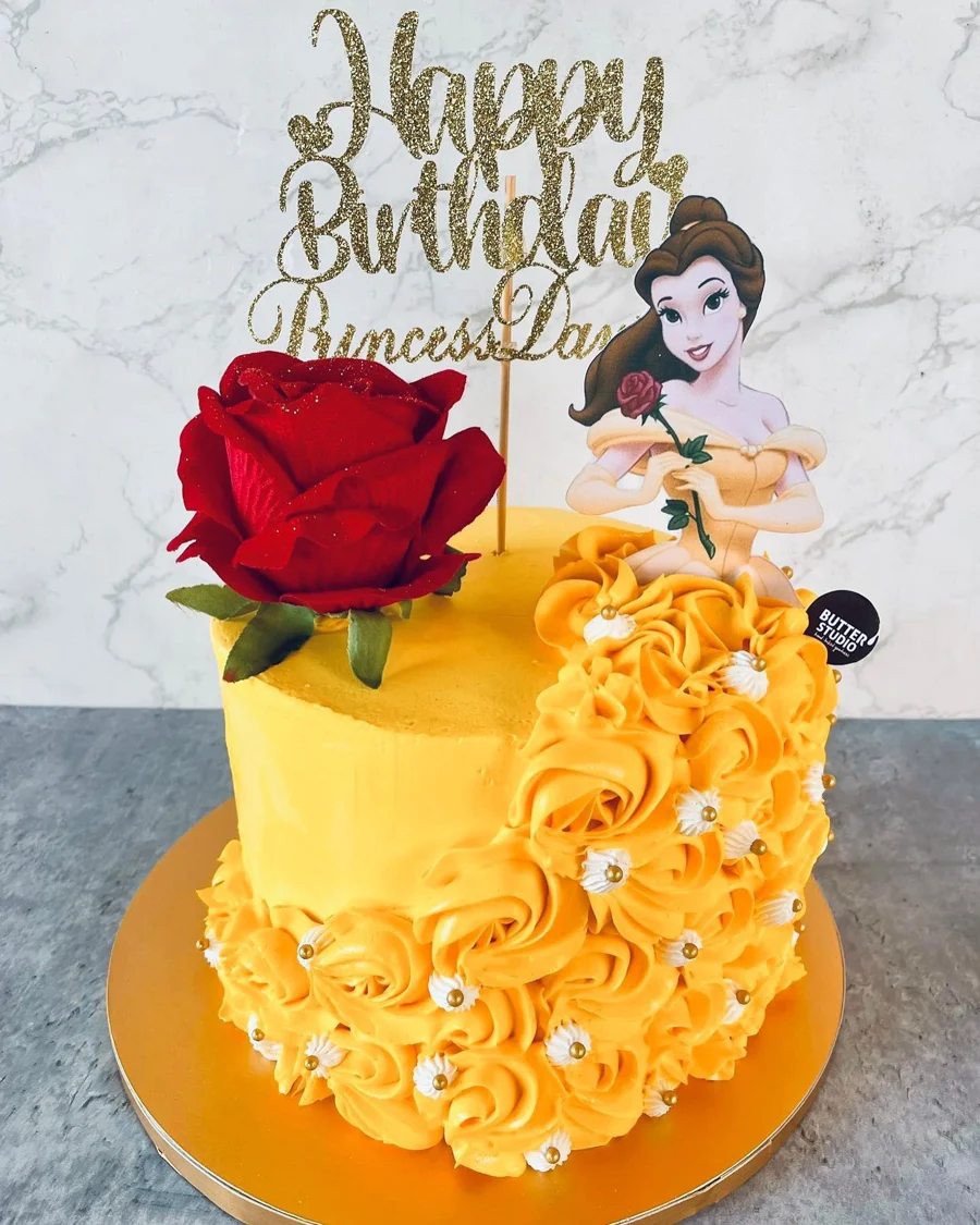 Snow White themed yellow birthday cake