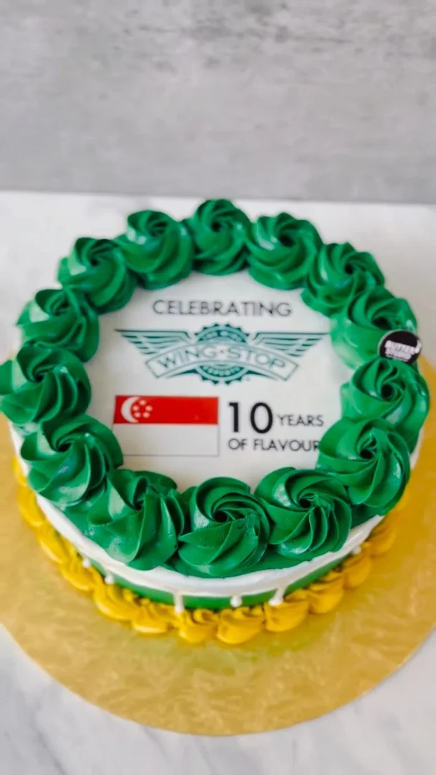 Green celebration cake with a company logo
