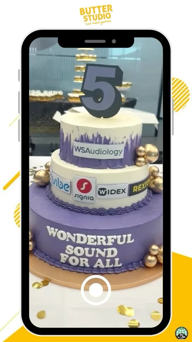 Celebration cake displayed through a phone camera