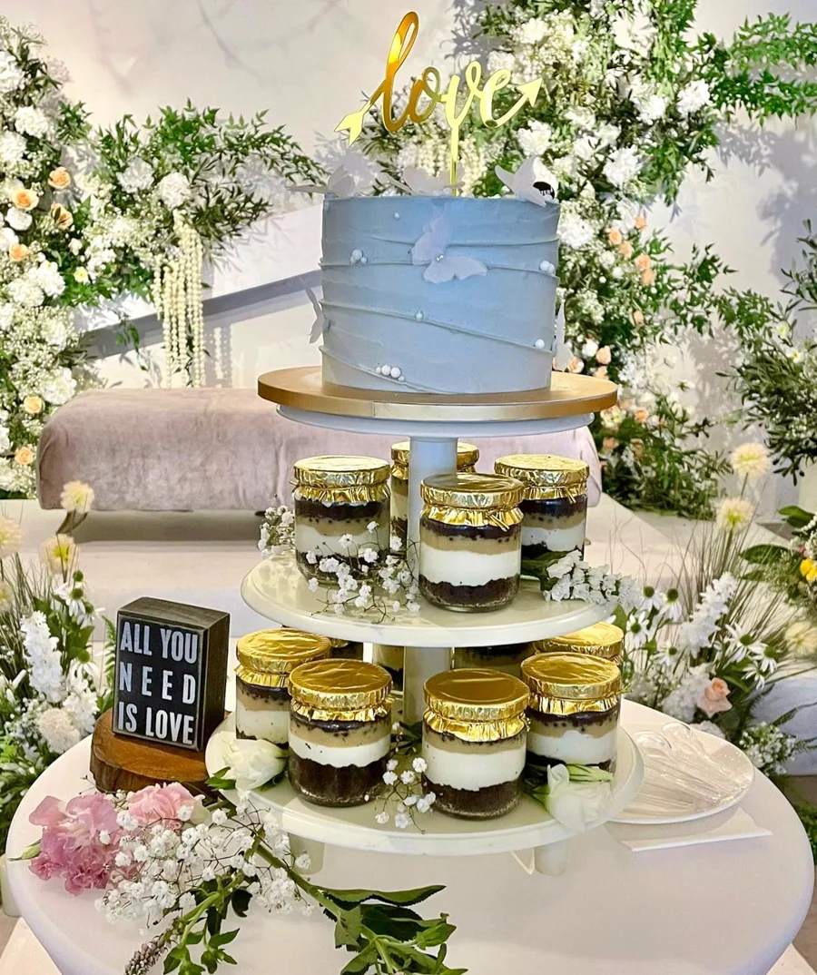 Blue celebration cake with matching cupcakes