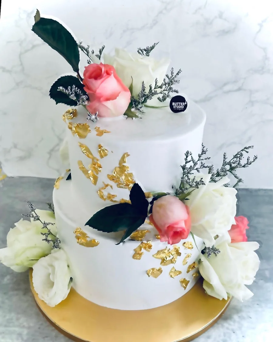 White floral celebration cake with foliage