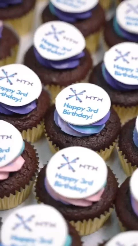 Purple cupcakes with printed corporate logos