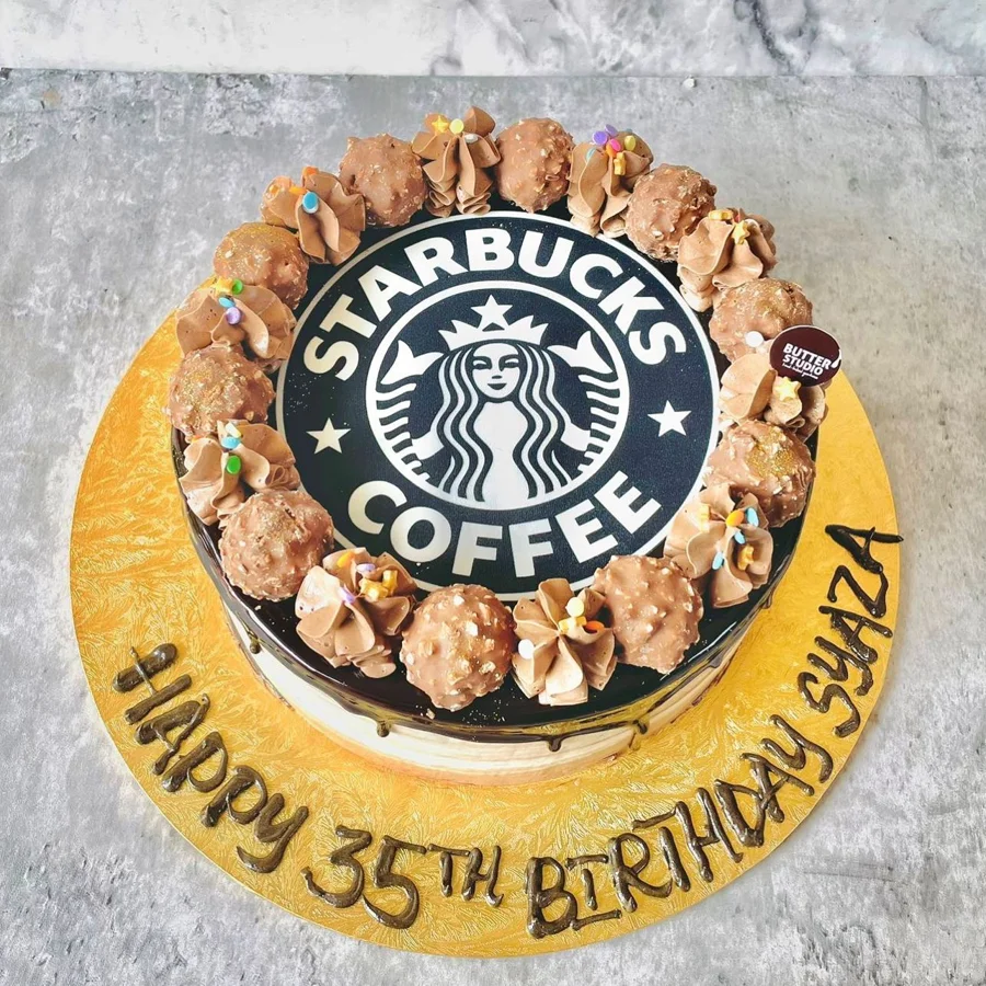 Round celebration cake with a coffee brand logo