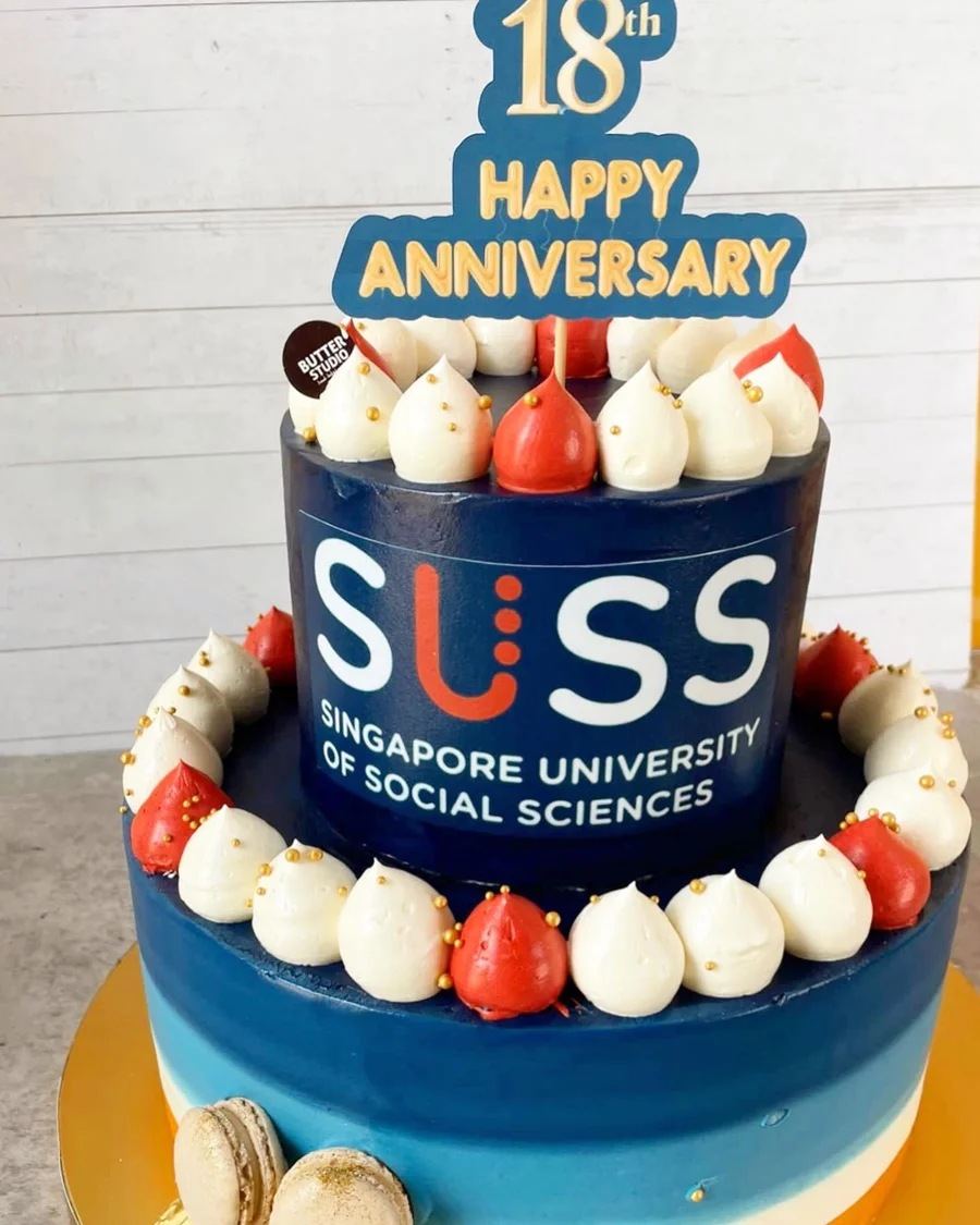 Tiered anniversary cake with blue and white decorations