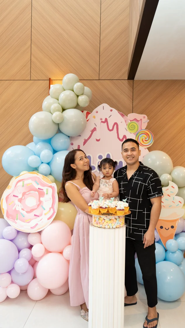 Celebration cake with a family and balloon display